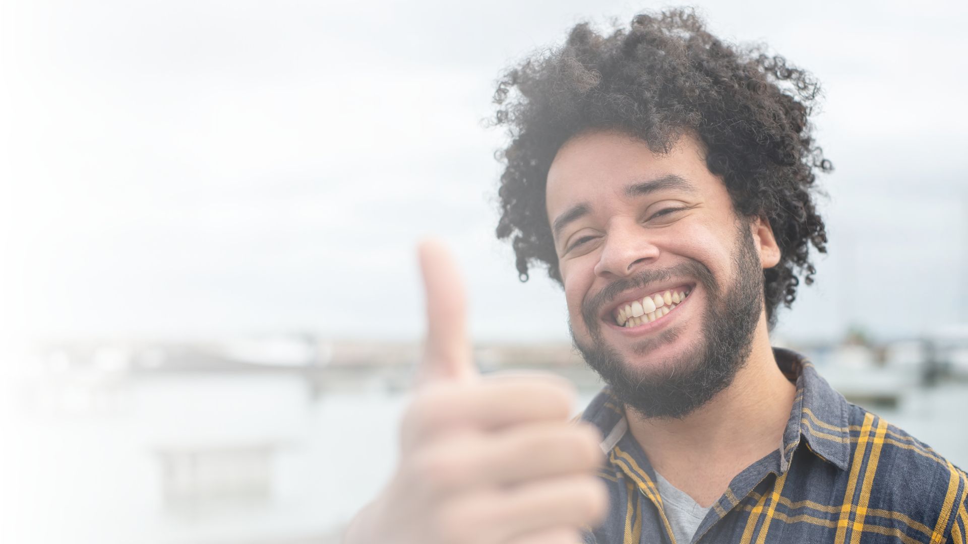Lachende man steekt zijn duim op